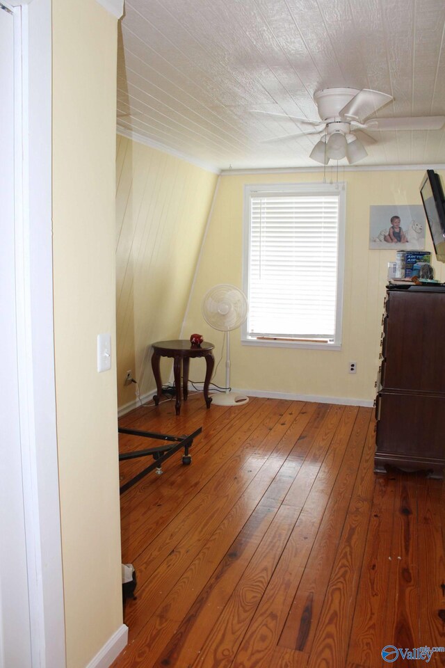 bonus room with hardwood / wood-style flooring, ceiling fan, and baseboards