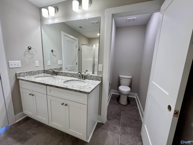 bathroom with toilet, a stall shower, visible vents, and a sink