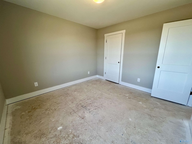 unfurnished room featuring baseboards