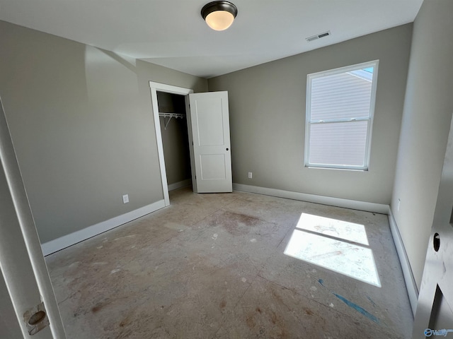 unfurnished bedroom featuring multiple windows, a closet, visible vents, and baseboards