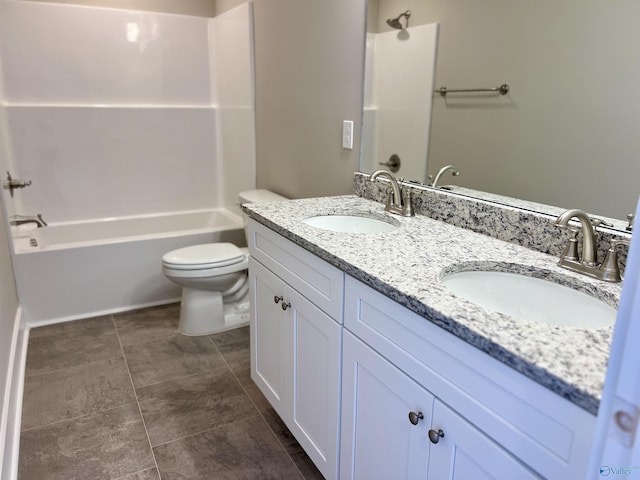 bathroom with double vanity, shower / bathing tub combination, a sink, and toilet