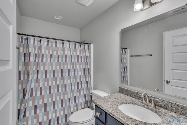 bathroom featuring vanity, toilet, and a shower with shower curtain