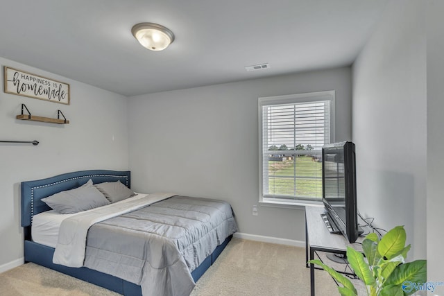 bedroom featuring light carpet