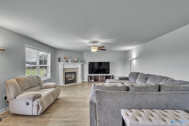 living room with ceiling fan and light hardwood / wood-style floors