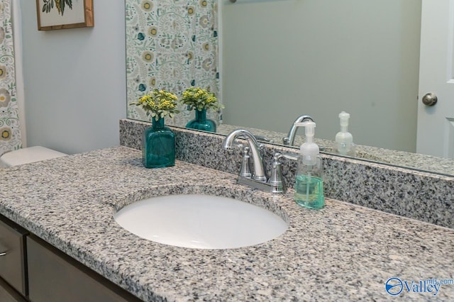 bathroom featuring vanity and toilet