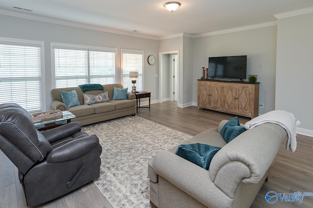 living room with crown molding and hardwood / wood-style flooring