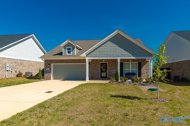 craftsman house with cooling unit and a front yard