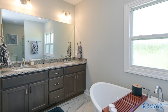 bathroom with a tub to relax in, tile patterned floors, and dual bowl vanity