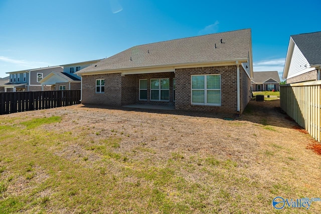 back of house featuring a yard