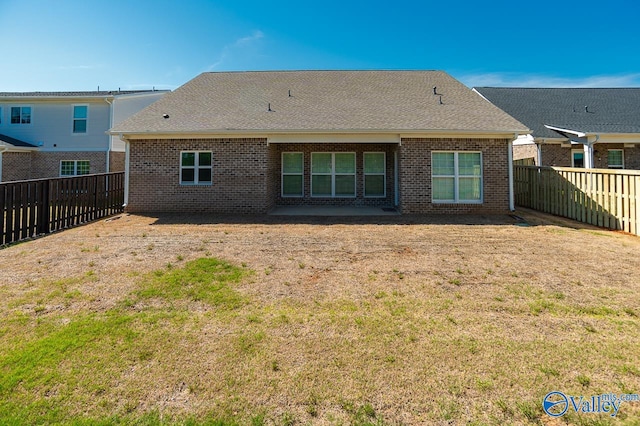 back of house with a lawn