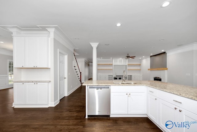 kitchen with dishwasher, white cabinetry, sink, and light stone countertops