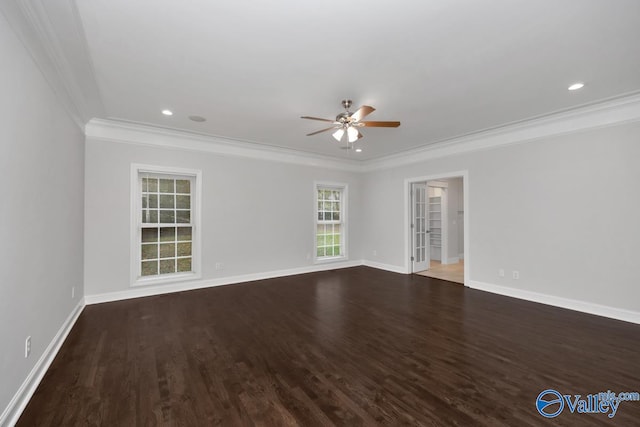 empty room featuring dark wood-type flooring, ceiling fan, and ornamental molding