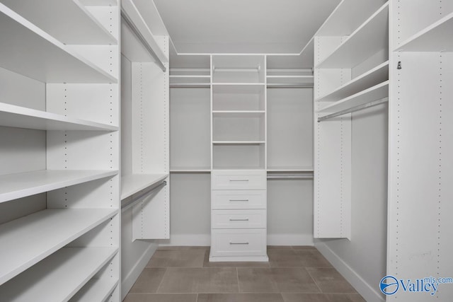 spacious closet featuring tile patterned flooring