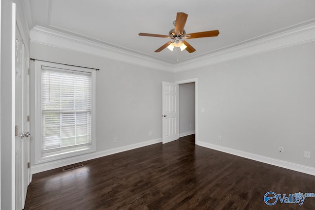 unfurnished room featuring dark wood-type flooring, ceiling fan, and crown molding