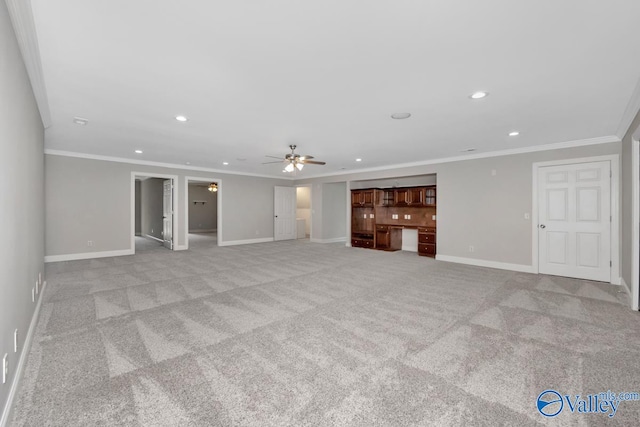 unfurnished living room featuring ceiling fan, light colored carpet, and ornamental molding