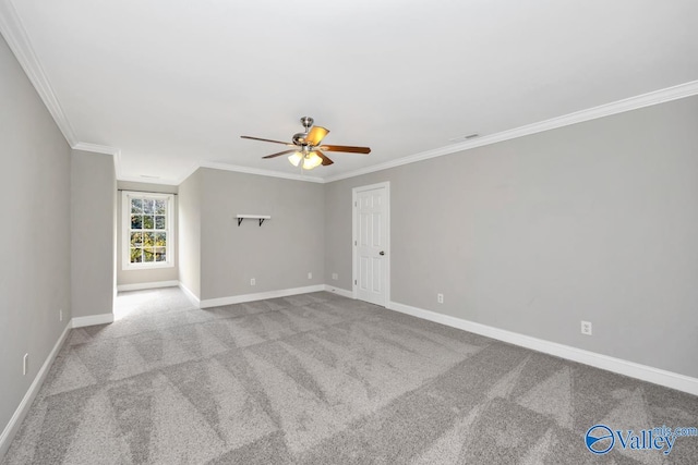 carpeted empty room featuring ceiling fan and crown molding