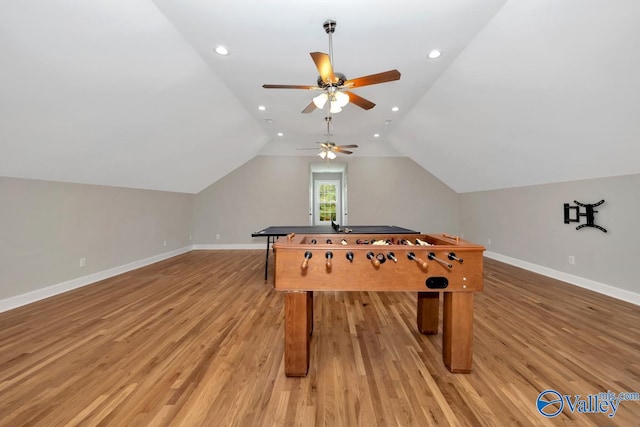 recreation room with lofted ceiling, ceiling fan, and light hardwood / wood-style flooring