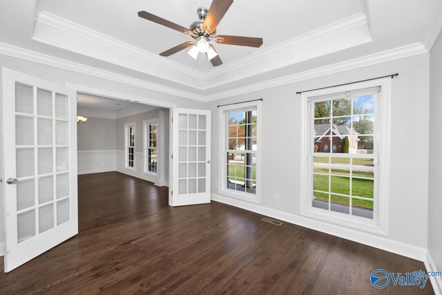 spare room with dark hardwood / wood-style floors, a raised ceiling, and french doors