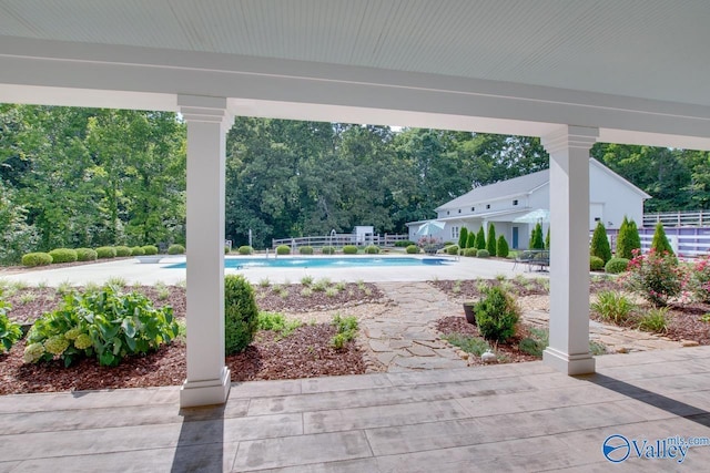 view of patio featuring fence and an outdoor pool