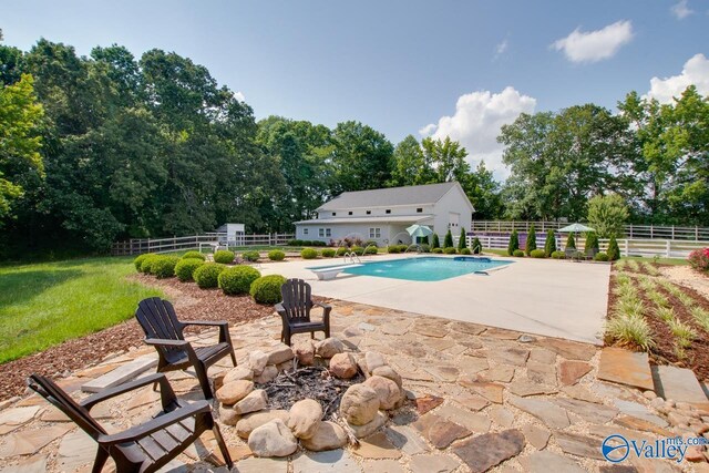 outdoor pool featuring fence, a patio, a diving board, and a lawn