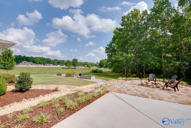 view of yard with a patio area and an outdoor fire pit