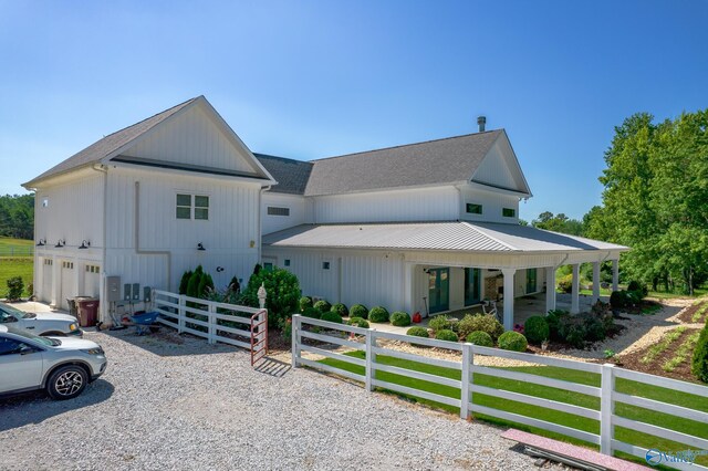 modern inspired farmhouse with an attached garage and fence private yard