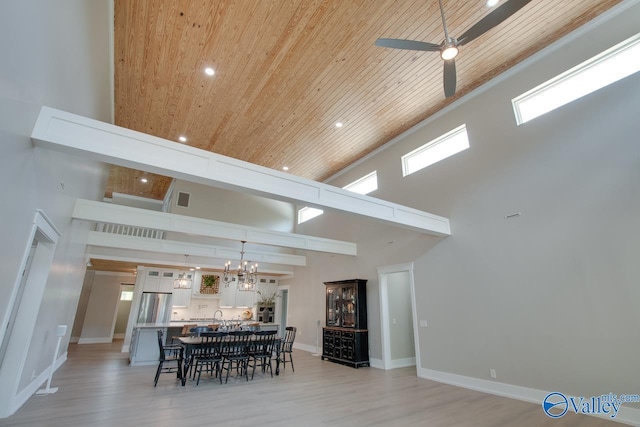 dining space featuring recessed lighting, wood ceiling, a high ceiling, and light wood-type flooring