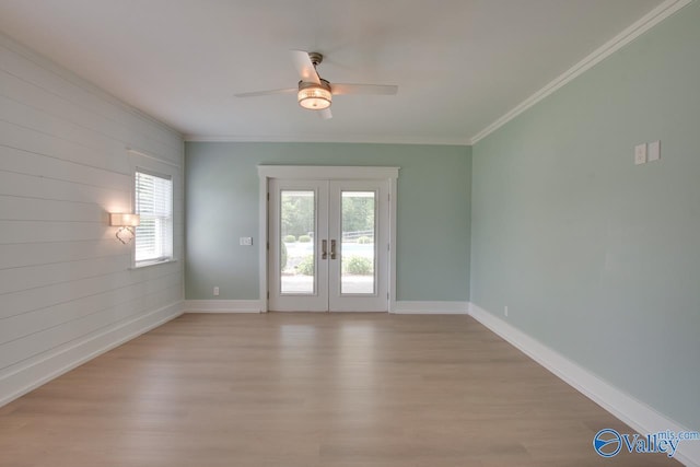 spare room with french doors, light wood finished floors, ceiling fan, and a wealth of natural light