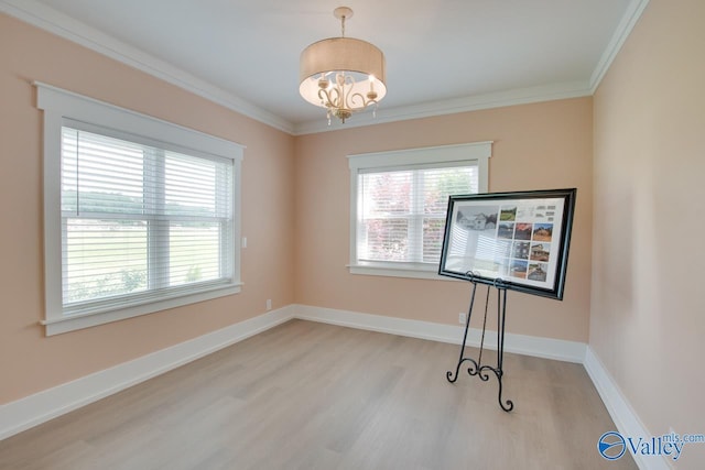 interior space with light wood-type flooring, baseboards, crown molding, and a chandelier