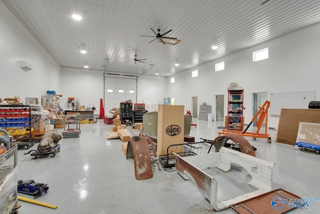 garage featuring recessed lighting, a ceiling fan, and a workshop area