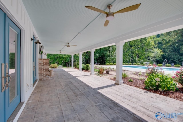 view of patio / terrace with a ceiling fan and an outdoor pool