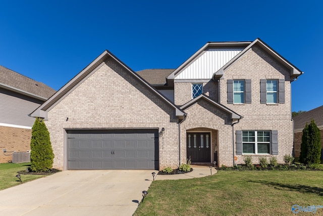 view of front facade with a front yard, central AC, and a garage