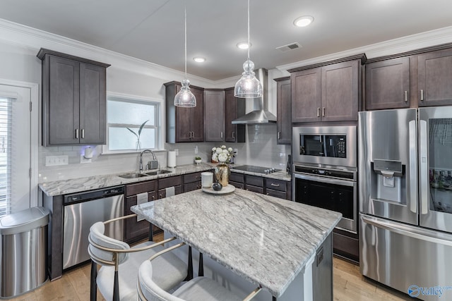 kitchen with a center island, a healthy amount of sunlight, appliances with stainless steel finishes, and pendant lighting