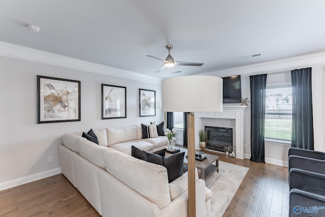 living room with ceiling fan, dark wood-type flooring, and ornamental molding