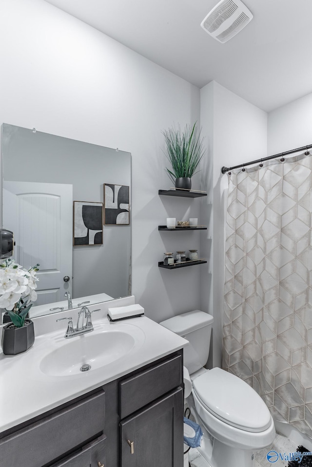 bathroom featuring tile patterned floors, a shower with curtain, vanity, and toilet