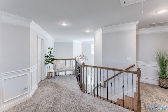 hall featuring carpet floors and crown molding