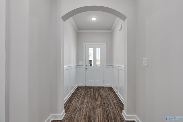 6208 Taramore Ln, Huntsville, AL 35806 - doorway featuring arched walkways, dark wood-style flooring, a decorative wall, ornamental molding, and wainscoting