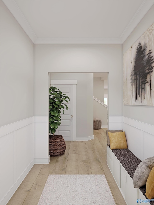 corridor featuring a wainscoted wall, crown molding, and wood finished floors