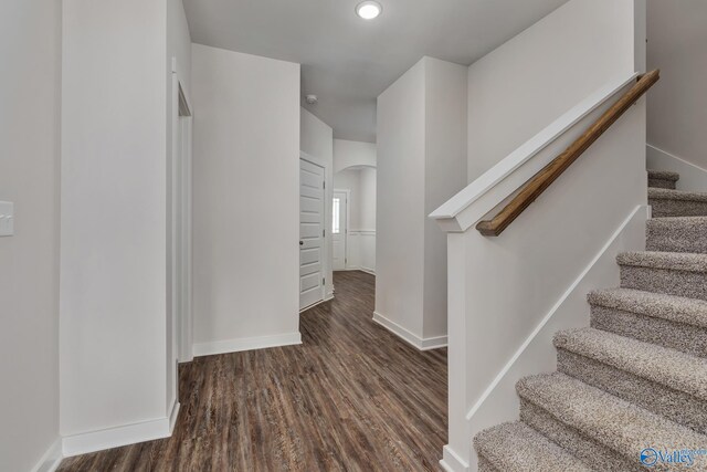 6208 Taramore Ln, Huntsville, AL 35806 - corridor with arched walkways, stairway, wood finished floors, and baseboards