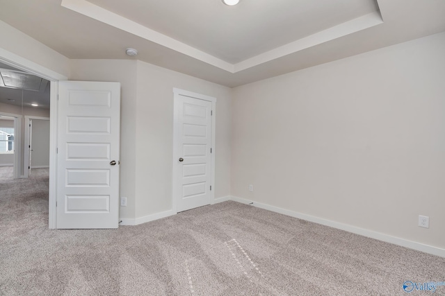 6208 Taramore Ln, Huntsville, AL 35806 - unfurnished bedroom with attic access, a raised ceiling, and carpet flooring
