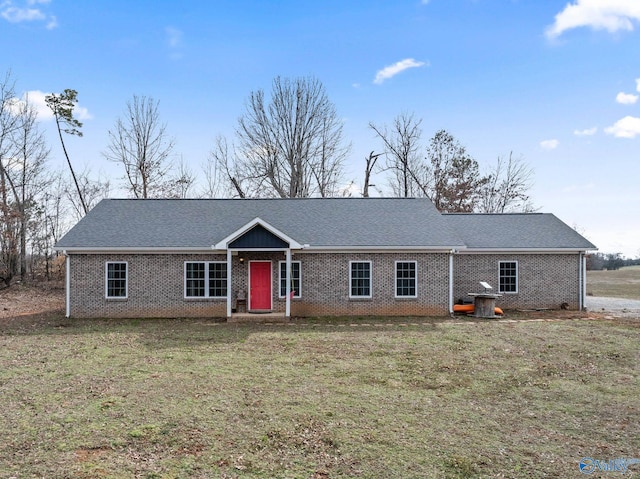 ranch-style home featuring brick siding and a front yard