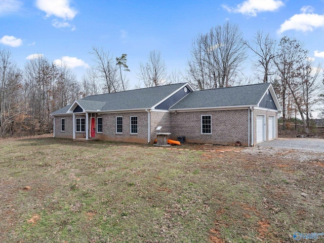 ranch-style home with aphalt driveway, brick siding, a shingled roof, a front yard, and a garage