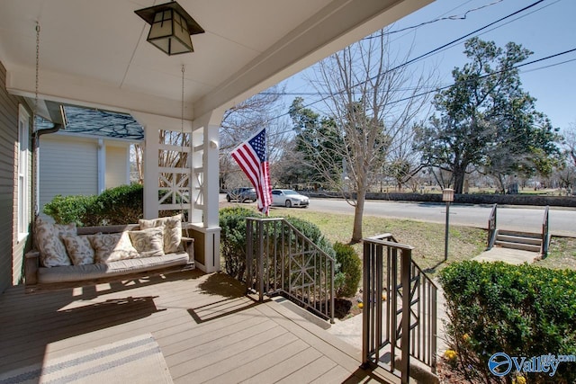 wooden terrace featuring covered porch