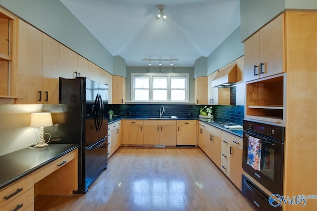 kitchen with a warming drawer, black appliances, light brown cabinets, a sink, and dark countertops