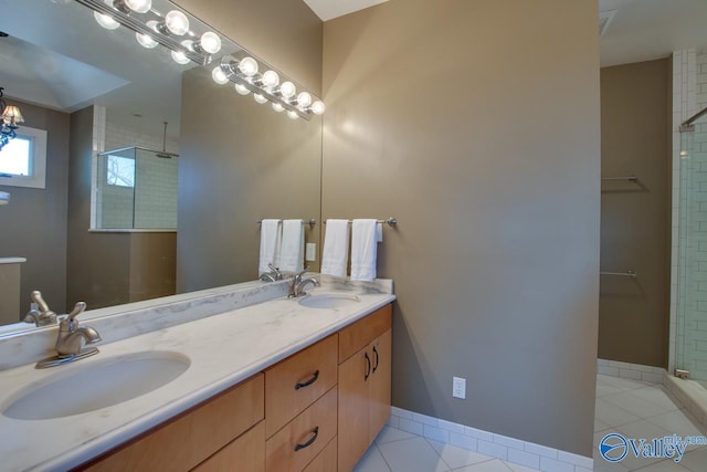 bathroom featuring a sink, double vanity, tile patterned flooring, and a tile shower