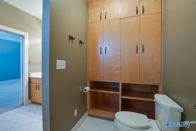 bathroom featuring tile patterned flooring, toilet, vanity, and baseboards