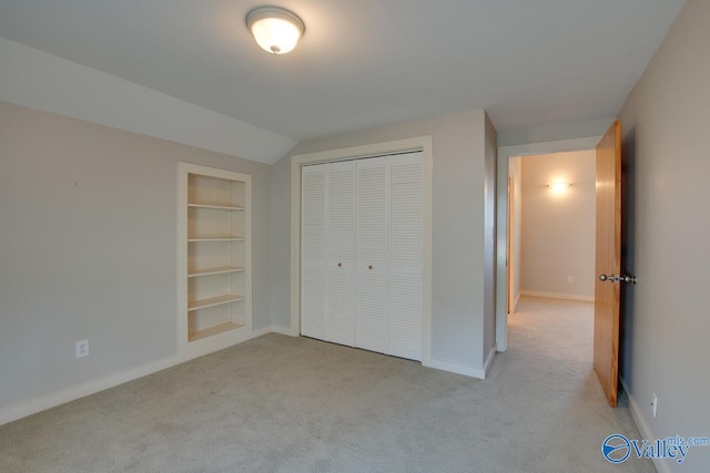 unfurnished bedroom with a closet, baseboards, and light colored carpet