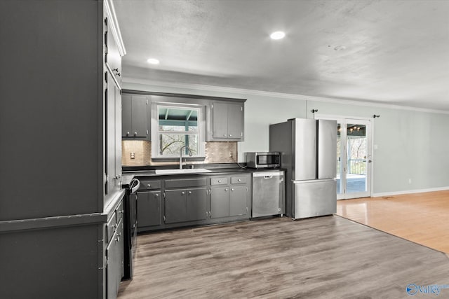 839 Bow Range Rd, Guntersville, AL 35976 - kitchen featuring light wood-style floors, ornamental molding, appliances with stainless steel finishes, a sink, and dark countertops