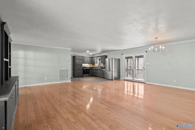 839 Bow Range Rd, Guntersville, AL 35976 - unfurnished living room featuring crown molding, visible vents, baseboards, and a chandelier