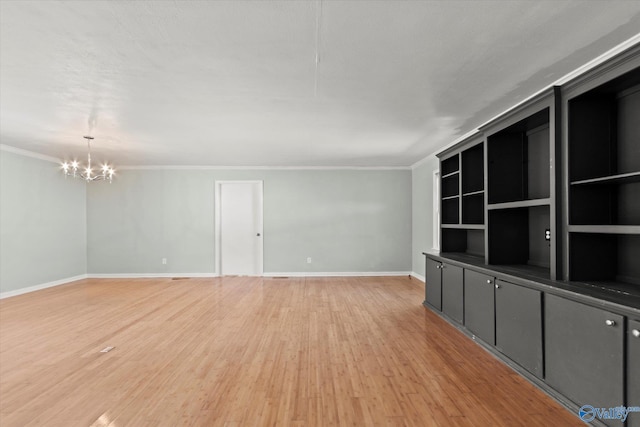 839 Bow Range Rd, Guntersville, AL 35976 - unfurnished living room featuring crown molding, light wood finished floors, and a notable chandelier